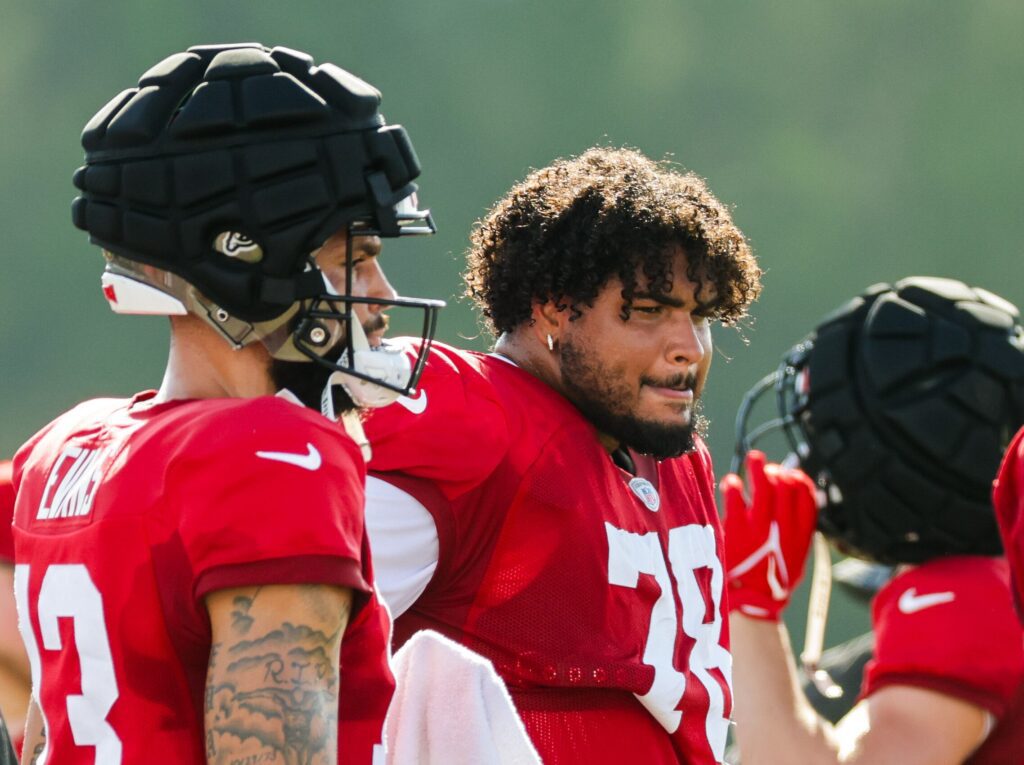 Tristan Wirfs (78) smiles as he talks with reporters during interviews after practice Monday.