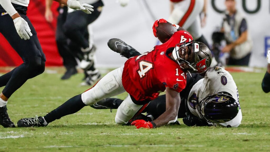 Bucs wide receiver Mike Evans (13) is helped by medical staff during the second quarter. He did not return.